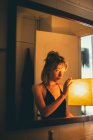 Portrait of a cute caucasian woman illuminated with a warm lamp. — Stock Photo