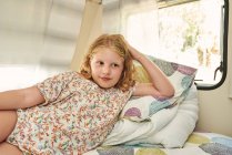 Girl lying in a caravan. She is relaxed on her vacation. — Stock Photo