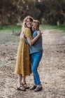Portrait of adult woman and senior mother hugging at park — Stock Photo