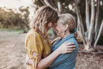 Lifestyle portrait of adult mother and senior mother smiling — Stock Photo