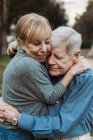 Close up portrait of senior adult couple embracing in forest — Stock Photo