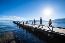 A family walks on a pier on a calm beautiful day in South Lake Tahoe, California. — Stock Photo