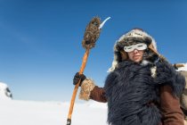 Native American hunter dressed in Traditional Fur clothing. — Stock Photo