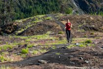 Жінка-спортсменка біжить поблизу гір — стокове фото