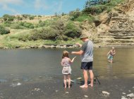 Family fishing at a scenic river spot — Stock Photo