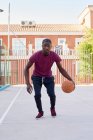 Young black man dribbling the basketball — Stock Photo