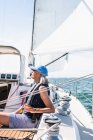 Middle age woman enjoying summer sail during golden hour — Stock Photo