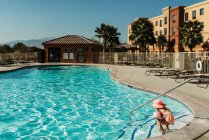 Jeune fille d'âge préscolaire nageant dans la piscine en vacances à Palm Springs — Photo de stock