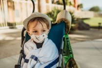 Close up portrait of young boy with mask on outside on vacation — Stock Photo