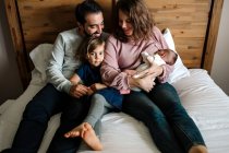 Happy family of four at home — Stock Photo