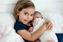 Cute little girl with her baby sister — Stock Photo