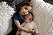 Cute little girl with her baby sister — Stock Photo