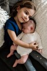 Menina bonito com sua irmã bebê — Fotografia de Stock