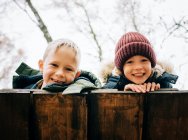 Siblings, friends in the forest smiling together happily — Stock Photo
