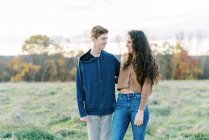 Two teenage siblings standing together smiling — Stock Photo