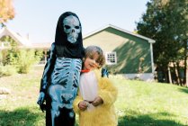 Two siblings in costumes getting ready for trick or treating — Stock Photo