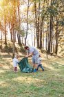 Group of volunteer families collecting garbage in a natural park — Stock Photo
