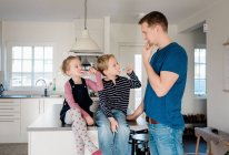 Father showing his kids how to brush their teeth before school — Stock Photo