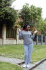African American woman dancing and listening music on street — Stock Photo