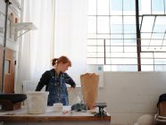Professional female sculptor working with plaster in her studio — Stock Photo
