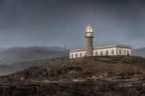 Leuchtturm und Turm an Küste und Meer — Stockfoto