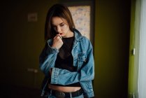 Portrait of a thoughtful young beautiful woman in denim jacket — Stock Photo