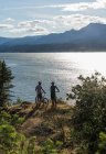 A young couple enjoy a view of the Columbia River while biking in OR. — Stock Photo