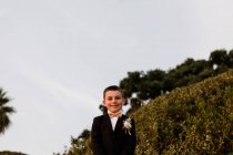 Low Angle View of Young Boy in Tux at Beach in San Diego — Stock Photo
