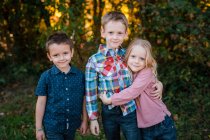 Family brothers and sister portrait outdoors in nature — Stock Photo