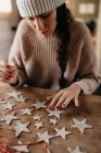 Young woman creating star ornaments with clay for Christmas — Stock Photo