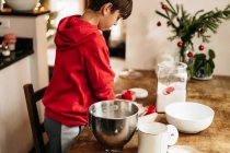 Child making cookie dough for Christmas cookies — Stock Photo