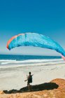 Junger Mann beim Gleitschirmfliegen am Strand der Pazifikküste in Baja, Mexiko — Stockfoto
