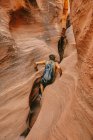 Young man exploring narrow slot canyons in Escalante, during summer — Stock Photo
