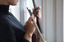 Female hands holding alt violin with musician bow, close up detail — Stock Photo