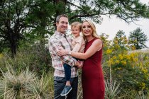 Portrait of a happy three person family outside — Stock Photo