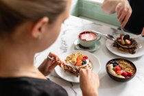 People enjoying breakfast, pancakes and sweets — Stock Photo