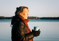 Schwedin hält nach Kaltwasserschwimmen ein Heißgetränk in der Hand — Stockfoto