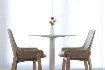 Modern interior with table and chairs on background — Stock Photo