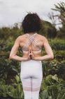 A strong female practices yoga in a field of vegetables — Stock Photo