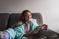 Carino bambina guardando video sul smarthpone — Foto stock