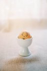 Funny cartoon art easter egg in porcelain dish with light background — Stock Photo