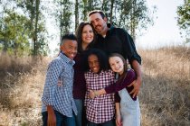 Family of Five Standing in Field Smiling for Camera — Stock Photo