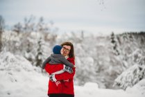 Nonna che tiene il nipotino fuori nella neve in inverno Norvegia — Foto stock