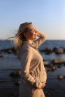 Happy pregnant woman close-up by the sea in summer. — Stock Photo