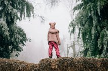 Girl stood in the frosty forest looking into the fog in England — Stock Photo