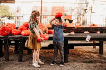 Cute boy and girl with pumpkins — Stock Photo