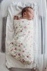Newborn baby boy in bassinet wrapped in hospital blanket — Stock Photo