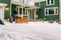 Mann auf Oldtimer restauriertem Traktor pflügt Schnee im Sturm — Stockfoto
