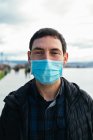 Young man on the street wearing a face mask — Stock Photo