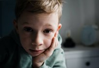 8 year old boy looking tired, thoughtful and expressive at home — Stock Photo
